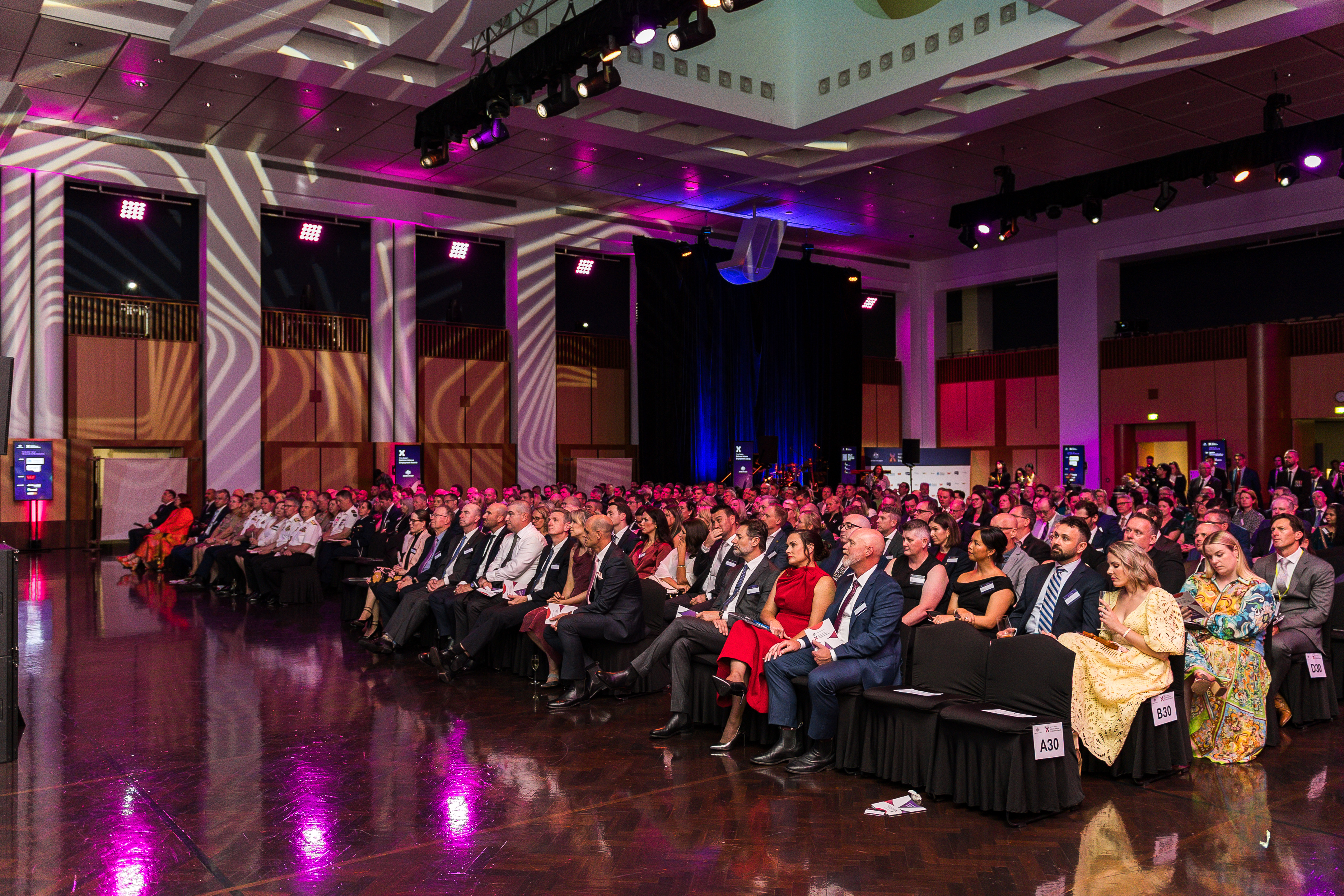 Great Hall with audience and pink lighting