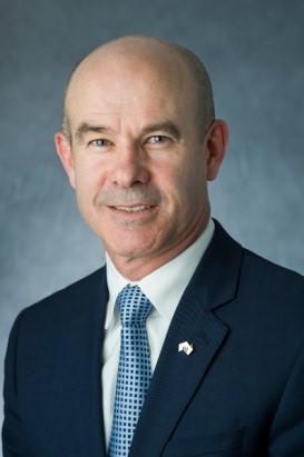 Close up of a man in a dark blue suit