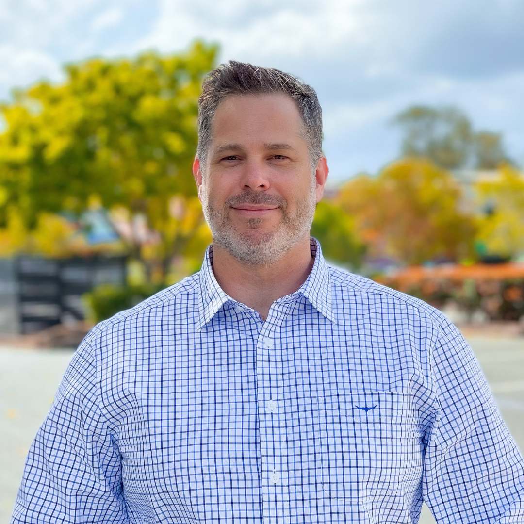 Image of Garth Chester wearing a light blue business shirt.