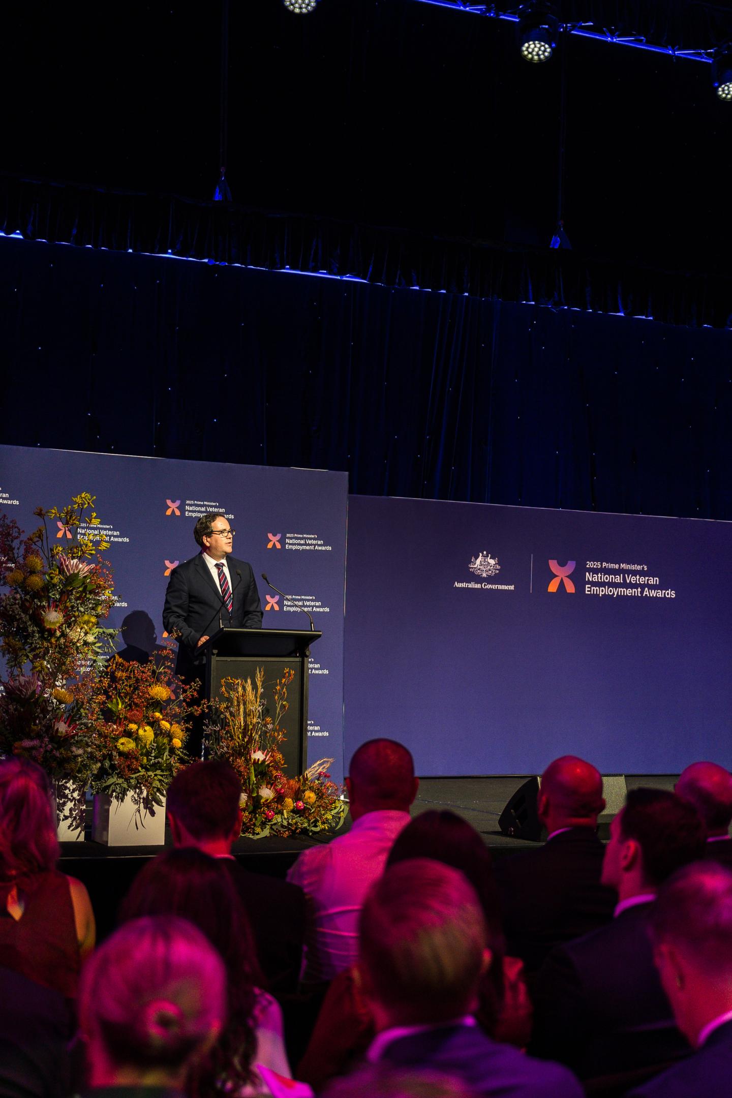 Minister Keogh presents from a podium