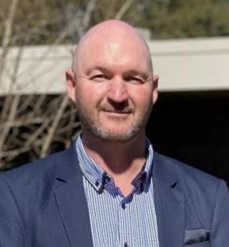 Man in suit jacket smiling
