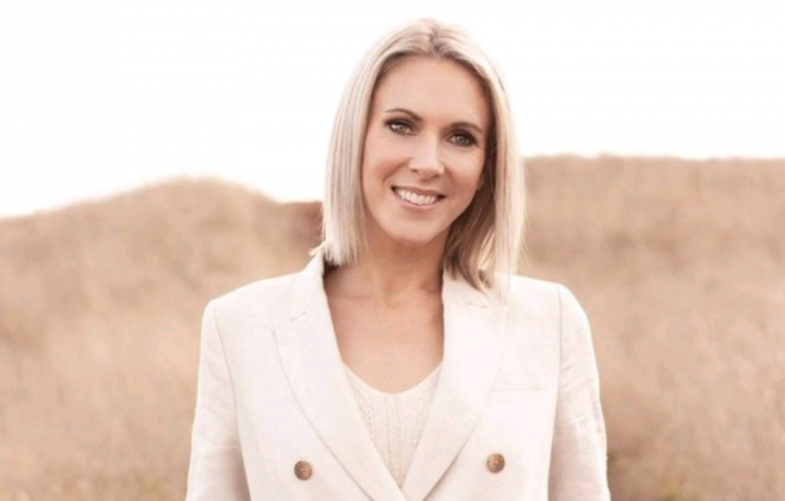 Smiling woman wearing cream jacket