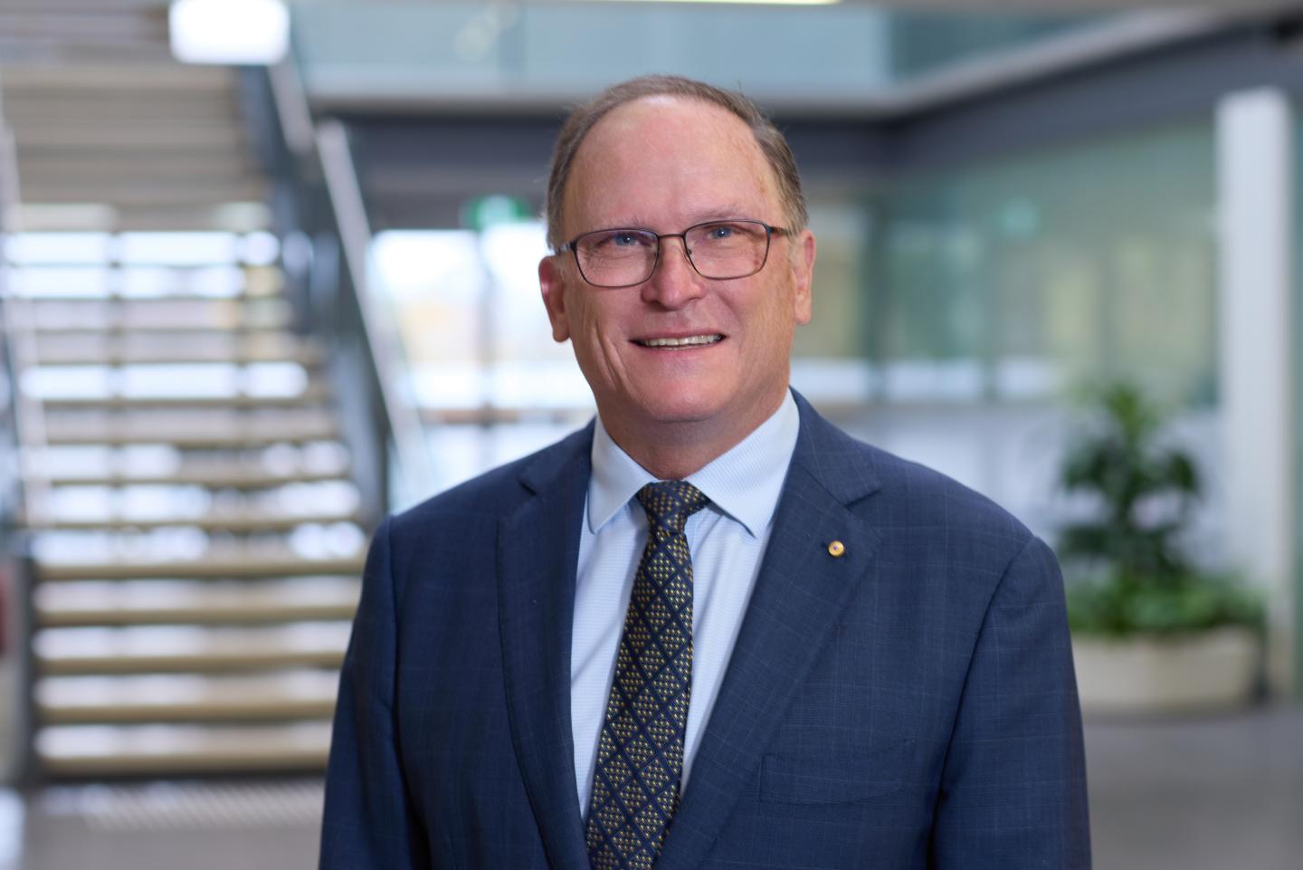 Man in suit with glasses smiling