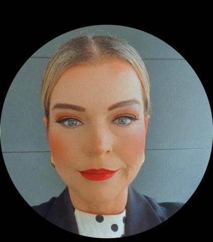 Headshot of a soman with tied back hair