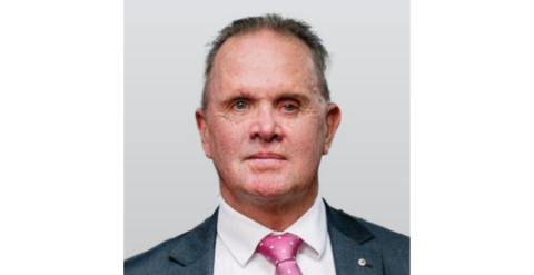 Headshot of a man in a dark suit