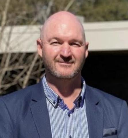 Man in suit jacket smiling