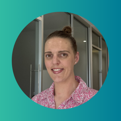 Headshot of a woman in a patterned blouse