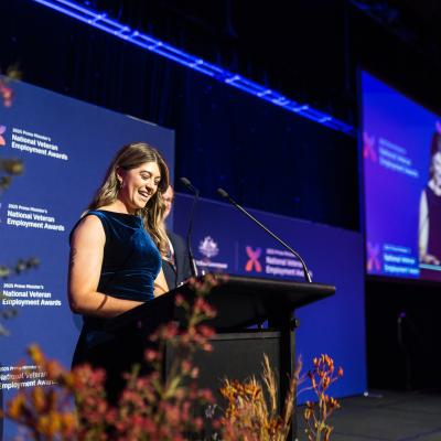 Woman standing at podium giving speech 