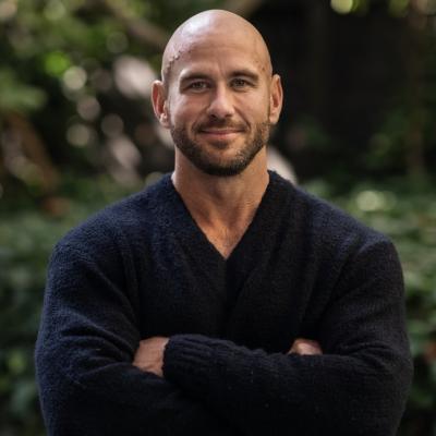 Portrait image of Scott Fairwether smiling at the camera with his arms crossed